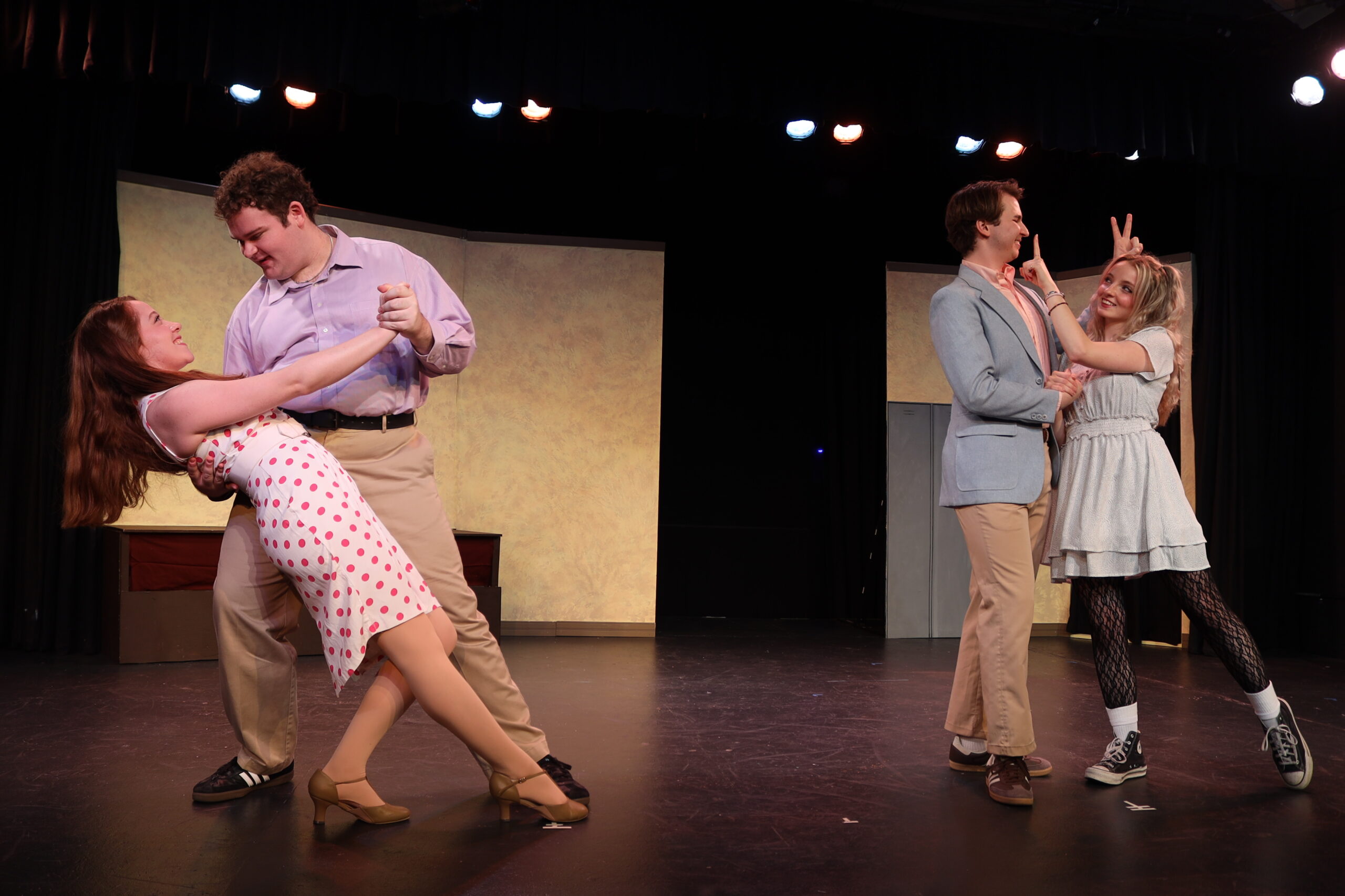 Two couples in final dance poses